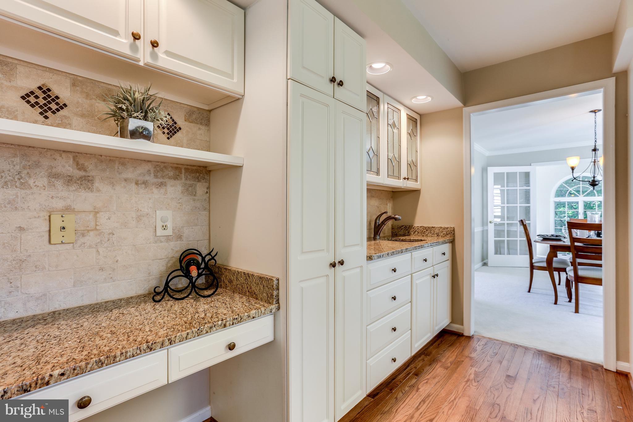 8258 Spring Branch Court Laurel, MD 20723 - Photo 9 of 26 a view of a sink and cabinet with wooden floor