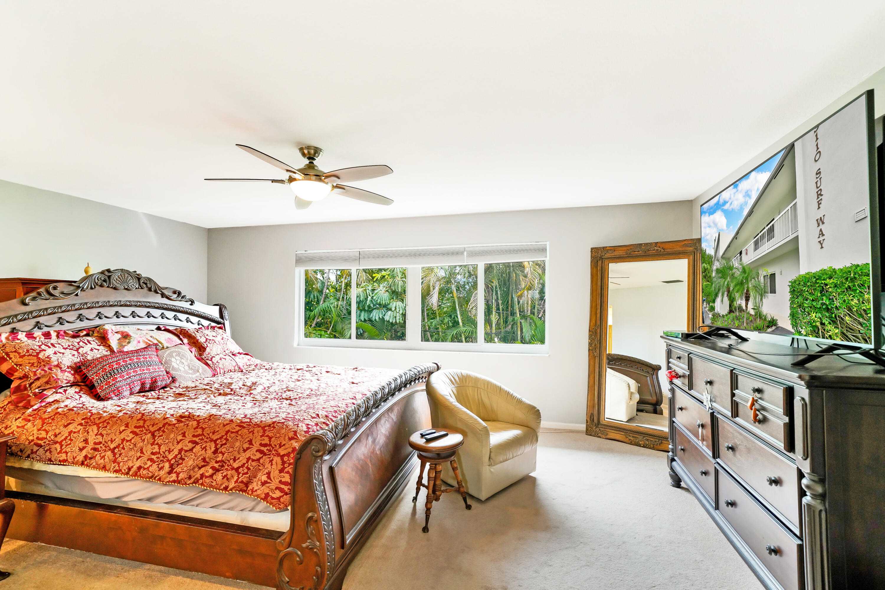 3110 Surf Way, Unit 2 Singer Island, FL 33404 - Photo 11 of 15 a bedroom with a bed and a table