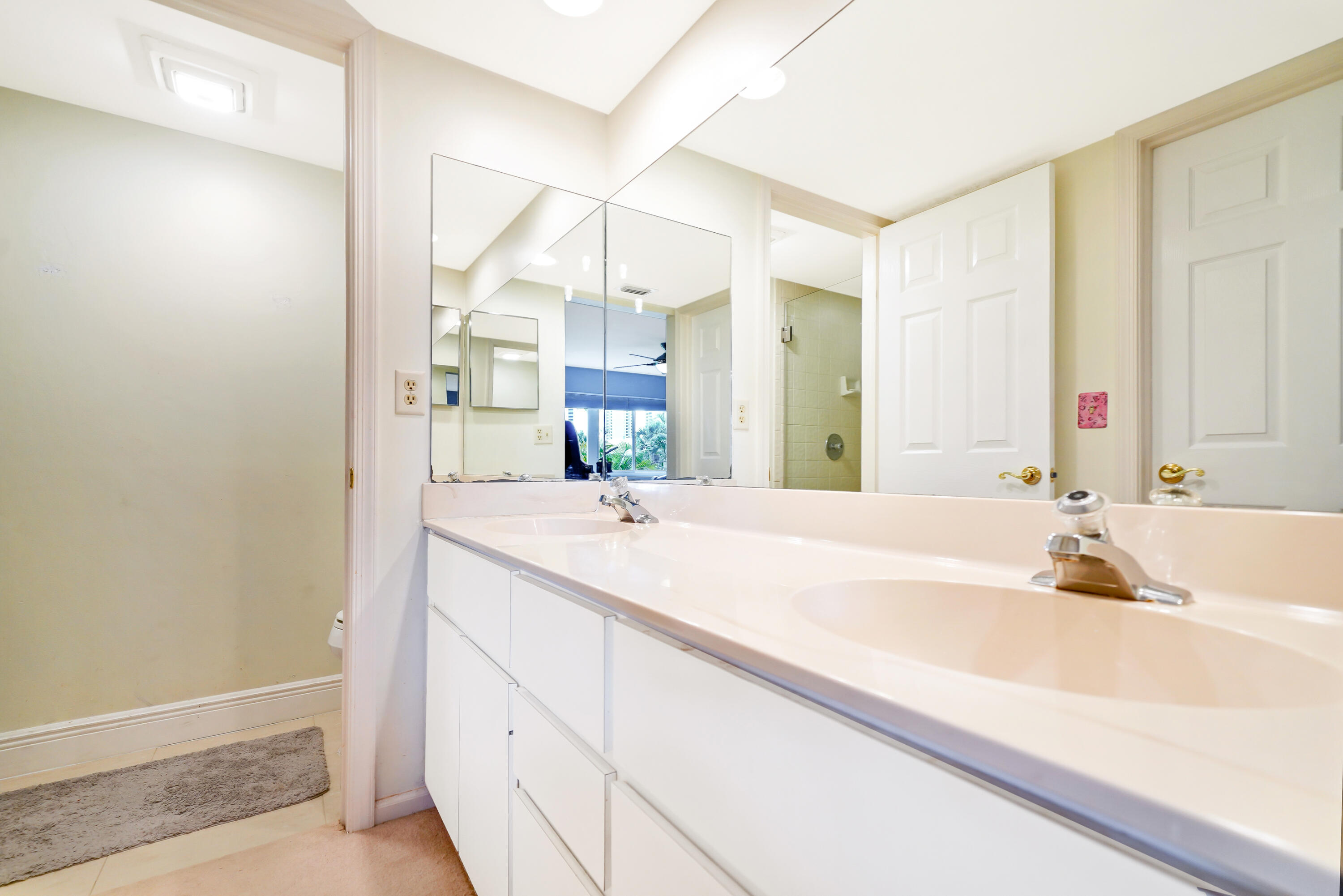 3110 Surf Way, Unit 2 Singer Island, FL 33404 - Photo 12 of 15 a bathroom with a bathtub sink and mirror