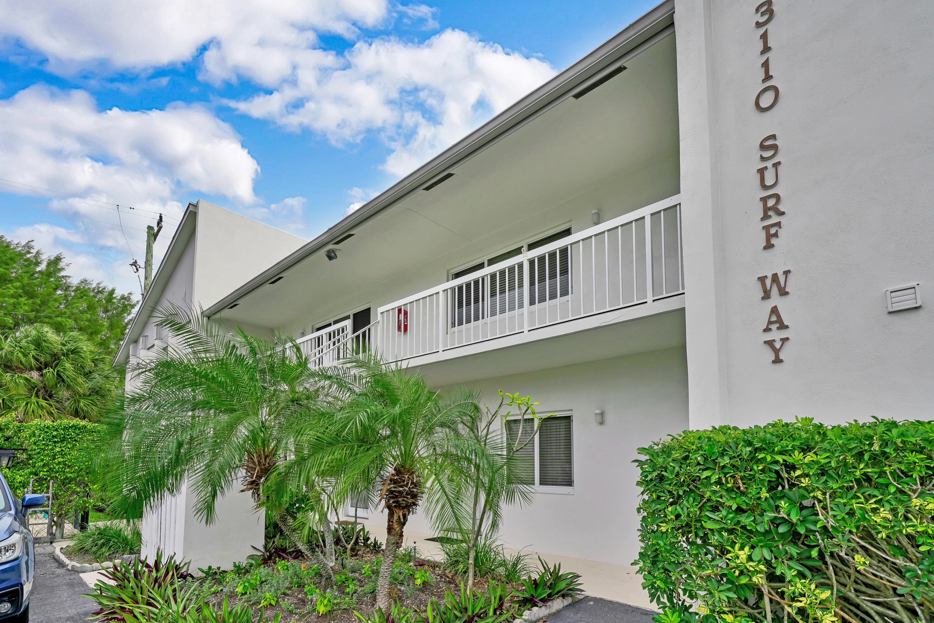 3110 Surf Way, Unit 2 Singer Island, FL 33404 - Photo 3 of 15 a balcony with potted plants and more windows