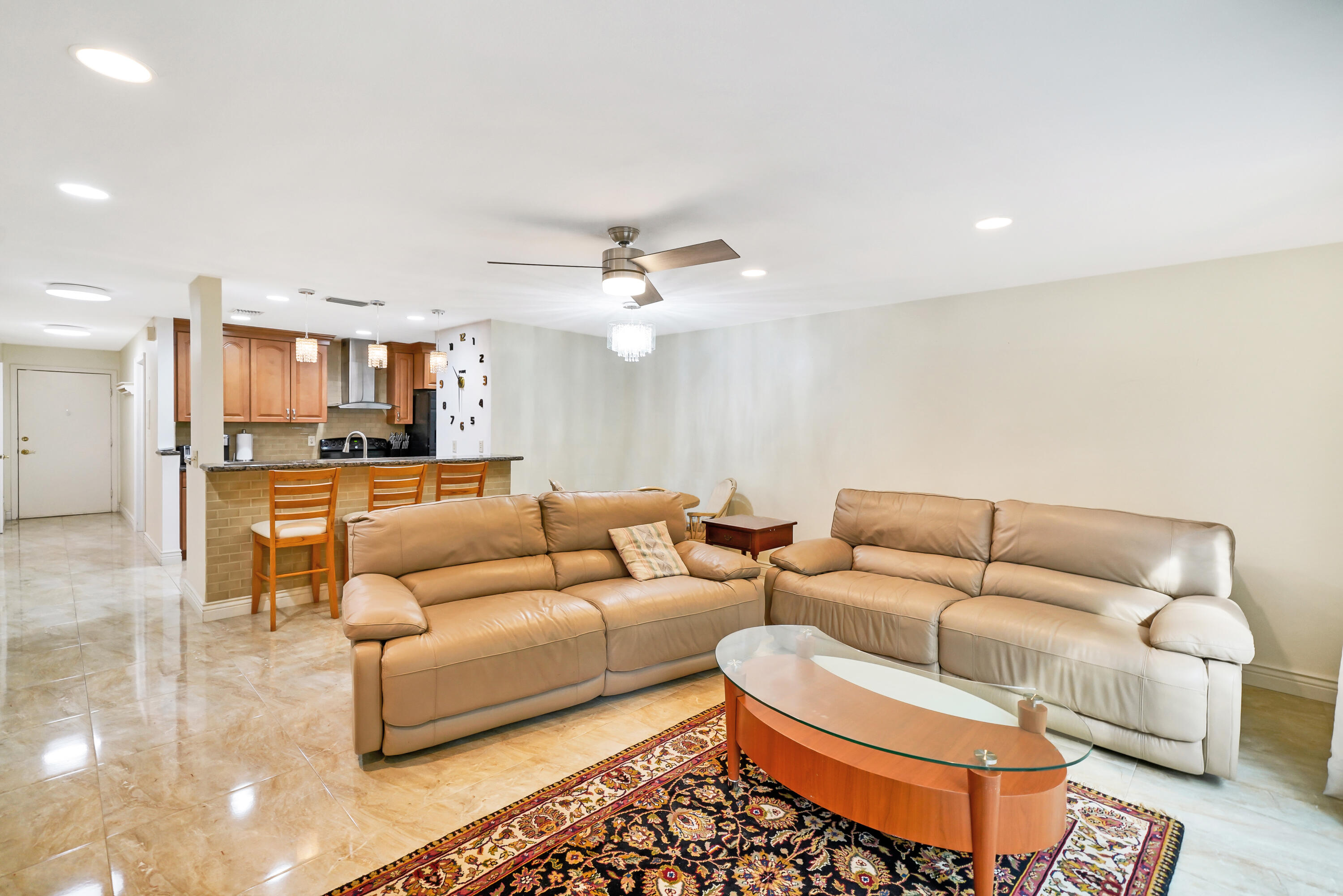 3110 Surf Way, Unit 2 Singer Island, FL 33404 - Photo 5 of 15 a living room with furniture and kitchen view