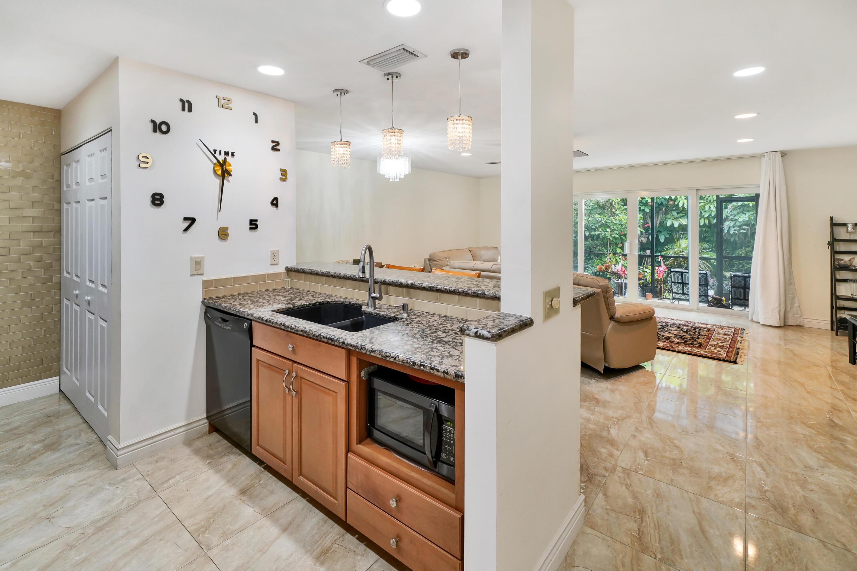 3110 Surf Way, Unit 2 Singer Island, FL 33404 - Photo 6 of 15 a kitchen with stainless steel appliances granite countertop a sink a stove and a refrigerator