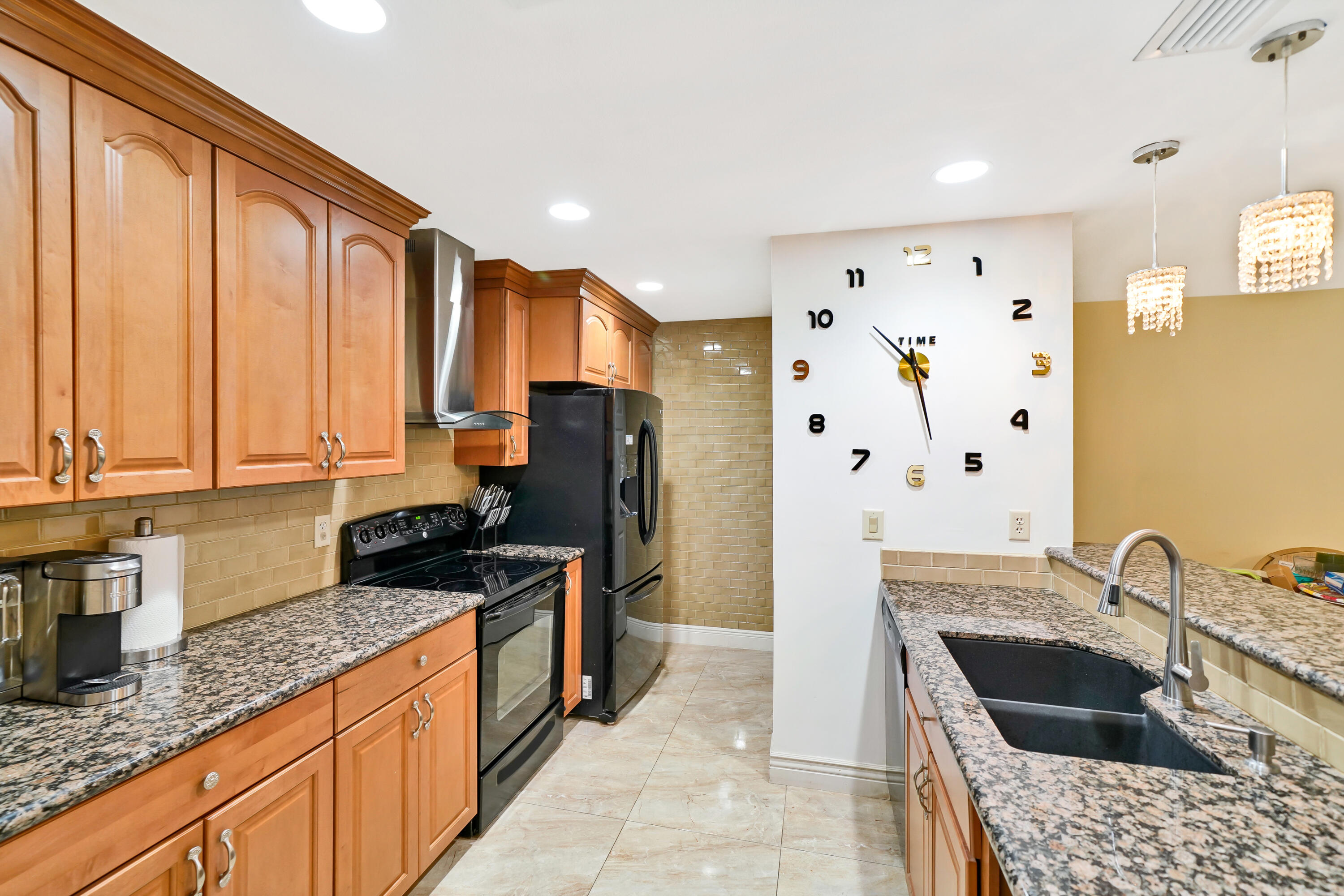 3110 Surf Way, Unit 2 Singer Island, FL 33404 - Photo 7 of 15 a kitchen with stainless steel appliances granite countertop a sink stove and refrigerator