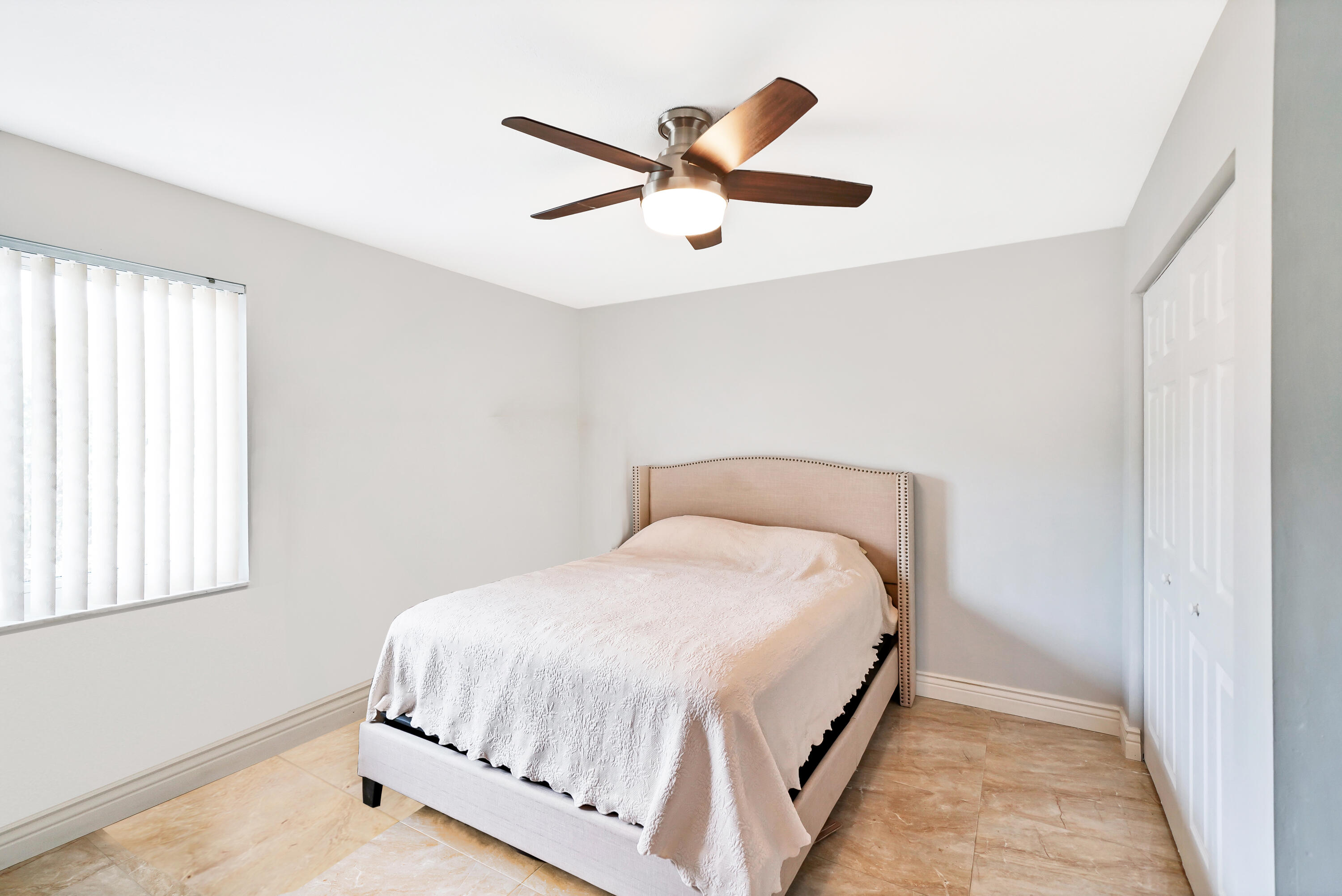 3110 Surf Way, Unit 2 Singer Island, FL 33404 - Photo 9 of 15 a bed room with a bed and a window
