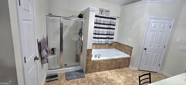 a bathroom with a bathtub and a shower