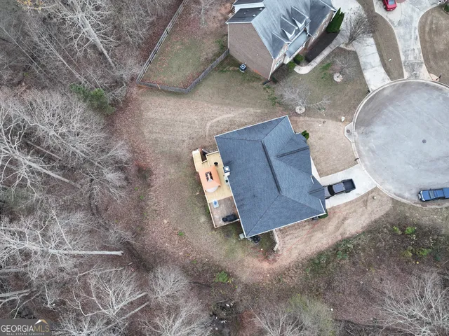 an aerial view of a house with outdoor space and a lake view