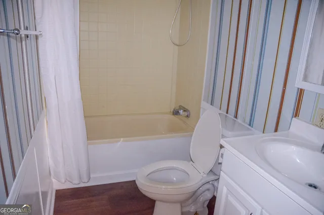 a view of a field with large trees