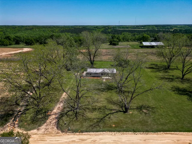 a aerial view of a house with pool and a big yard