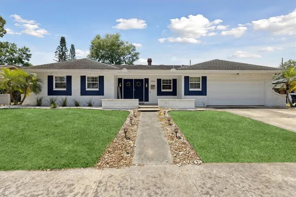a front view of house with yard and green space