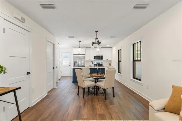 a view of a dining room with furniture and wooden floor