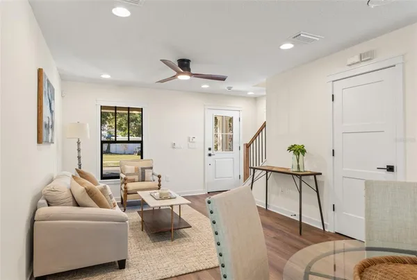 a living room with furniture and a wooden floor