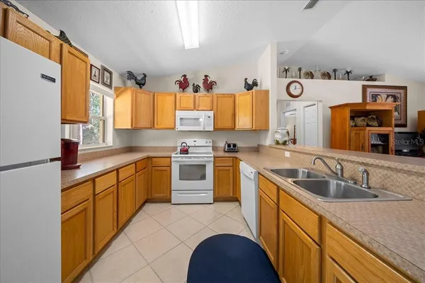 a kitchen with granite countertop a sink and cabinets