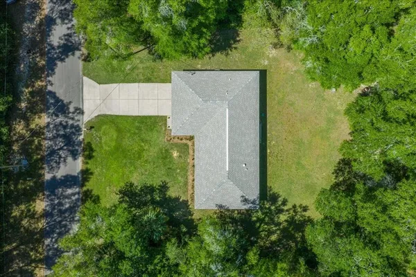 an aerial view of a house with a yard