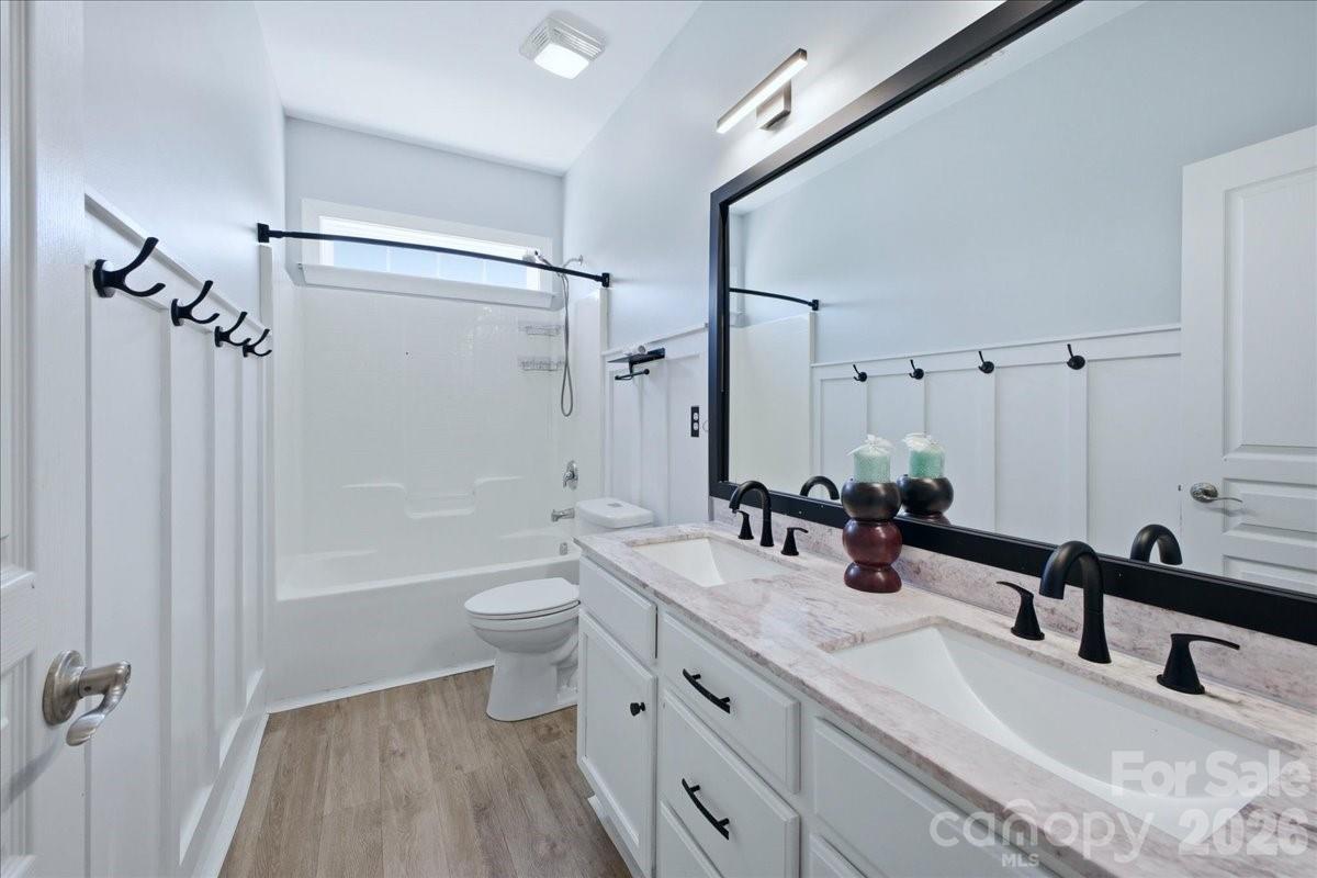 1825 Laveta Road Charlotte, NC 28269 - Photo 29 of 48 a bathroom with a double vanity sink toilet mirror and shower