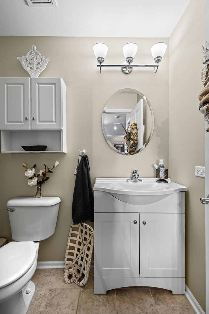 26832 West Hemlock Road Channahon, IL 60410 - Photo 13 of 25 a bathroom with a sink a toilet and mirror