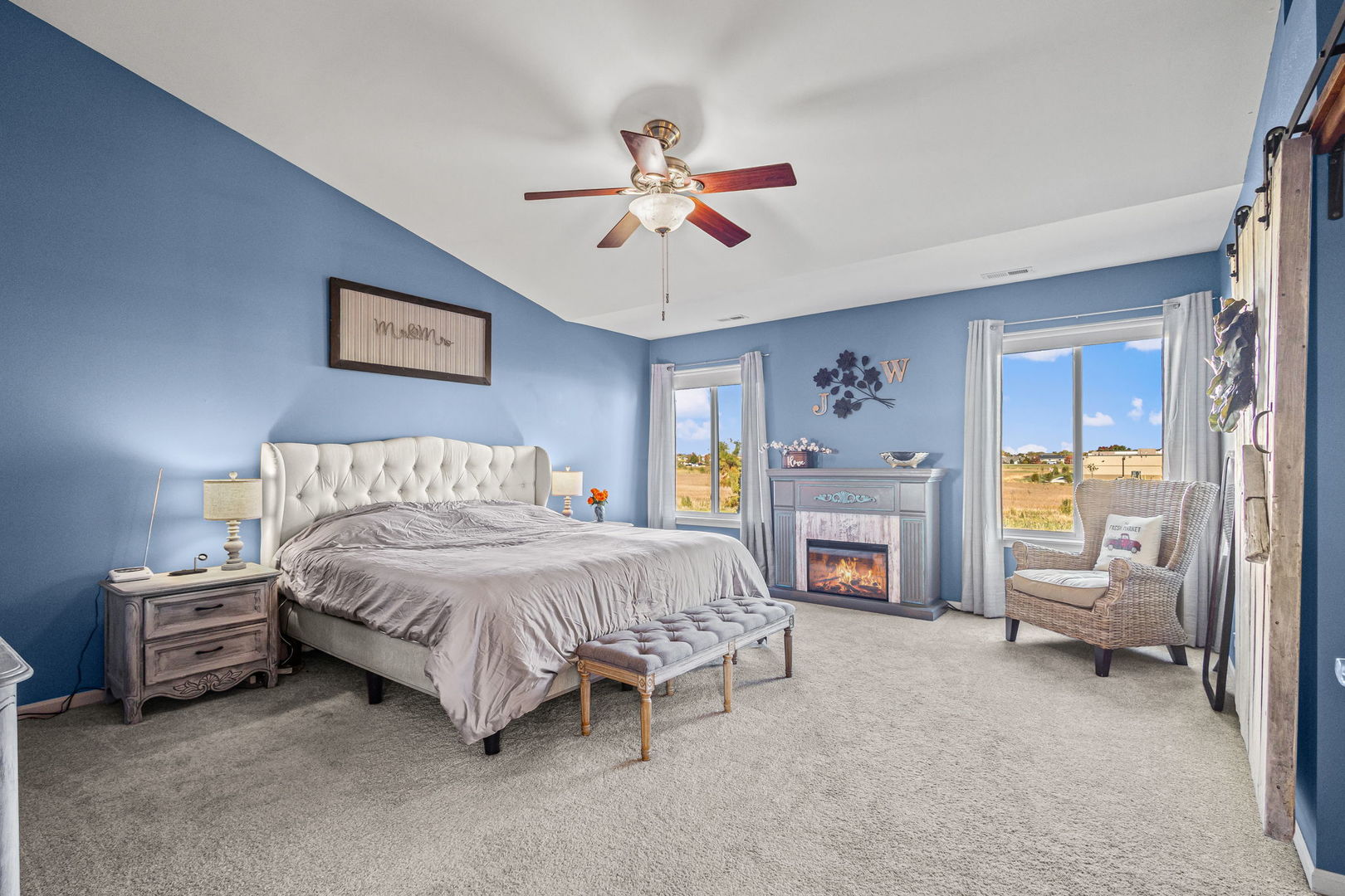 26832 West Hemlock Road Channahon, IL 60410 - Photo 16 of 25 a spacious bedroom with a bed a couch and a chandelier