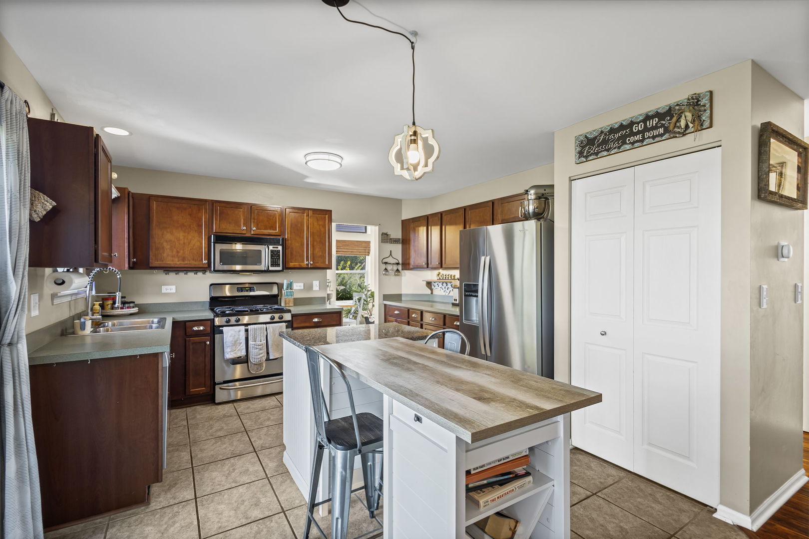 26832 West Hemlock Road Channahon, IL 60410 - Photo 8 of 25 a kitchen with stainless steel appliances granite countertop a stove refrigerator and a sink