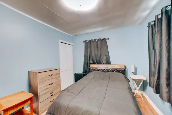 a bedroom with a bed and a closet