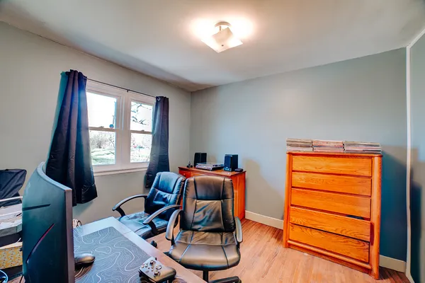 a view of a workspace with furniture and a window