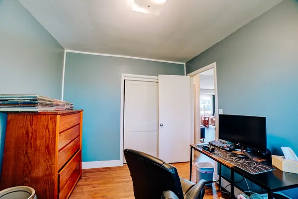 a view of a workspace with furniture and a window