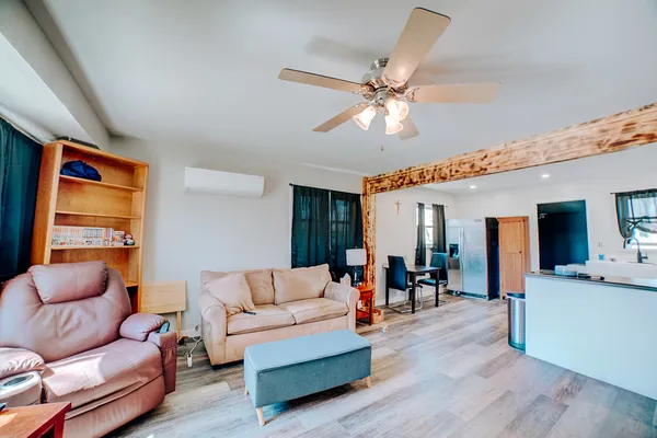 a living room with furniture and a wooden floor