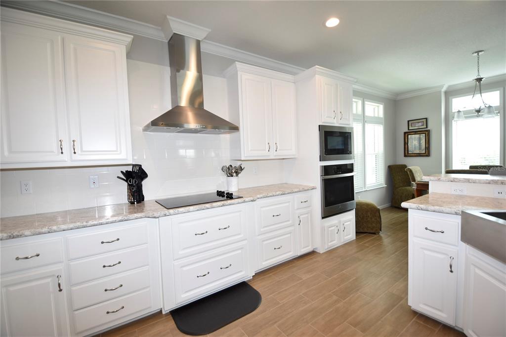 4354 North Manatee Loop, Unit 16A Punta Gorda, FL 33980 - Photo 3 of 33 a kitchen with granite countertop white cabinets and white appliances