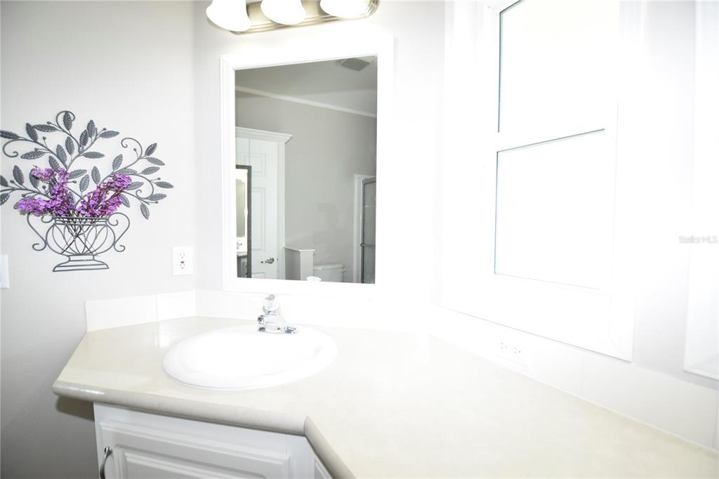 4354 North Manatee Loop, Unit 16A Punta Gorda, FL 33980 - Photo 31 of 33 a bathroom with a sink and a mirror