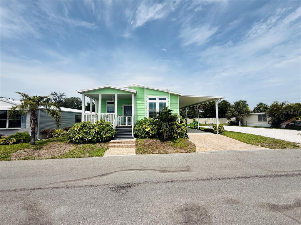 4354 North Manatee Loop, Unit 16A Punta Gorda, FL 33980 - Photo 32 of 33 front view of house with a yard and potted plants