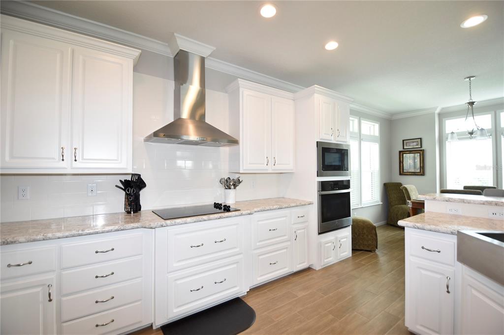 4354 North Manatee Loop, Unit 16A Punta Gorda, FL 33980 - Photo 4 of 33 a kitchen with granite countertop white cabinets and white stainless steel appliances
