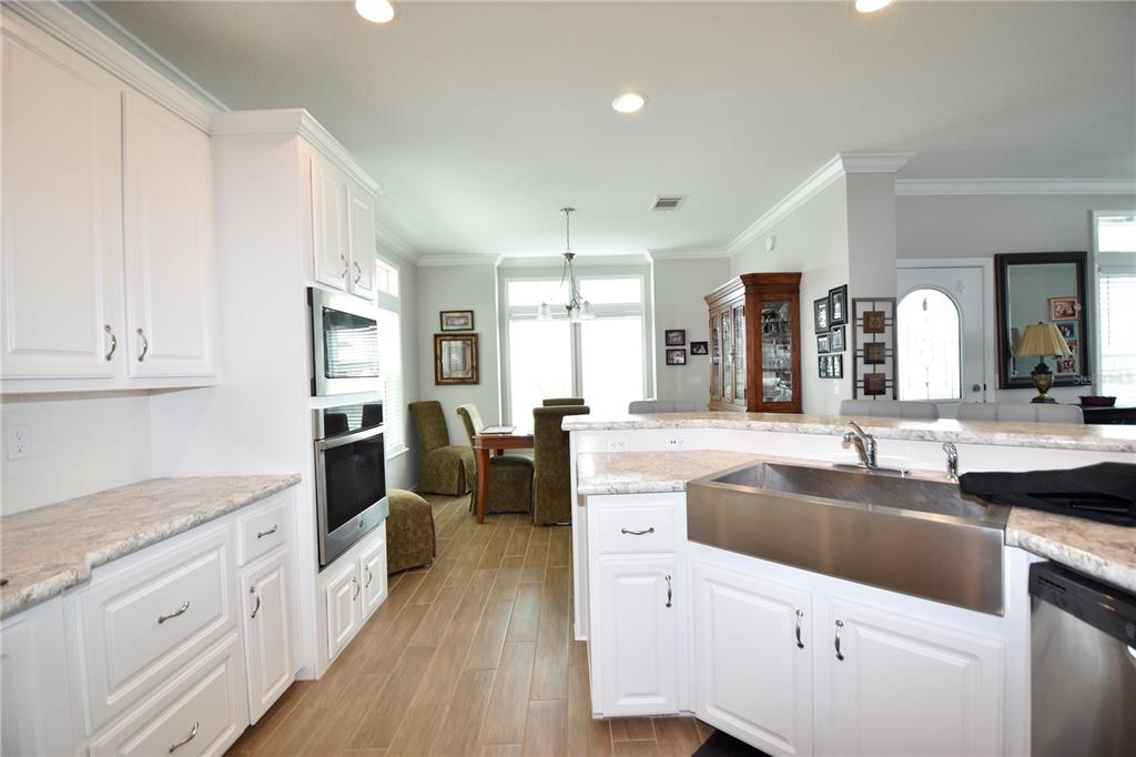 4354 North Manatee Loop, Unit 16A Punta Gorda, FL 33980 - Photo 5 of 33 a large kitchen with granite countertop a sink a counter space appliances and cabinets