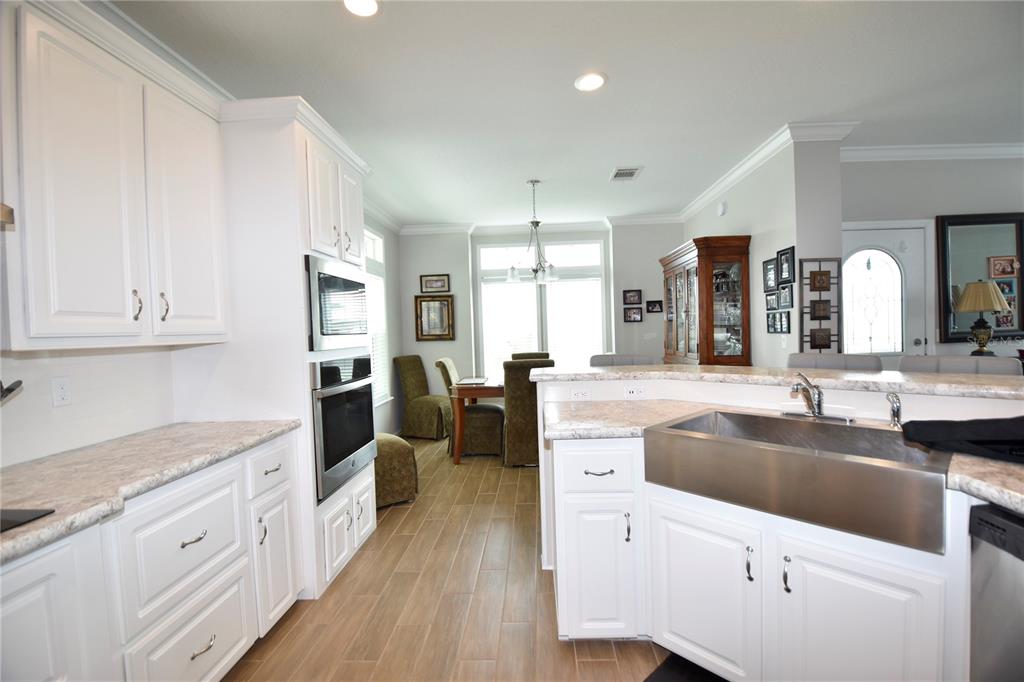 4354 North Manatee Loop, Unit 16A Punta Gorda, FL 33980 - Photo 6 of 33 a kitchen with granite countertop a sink and cabinets