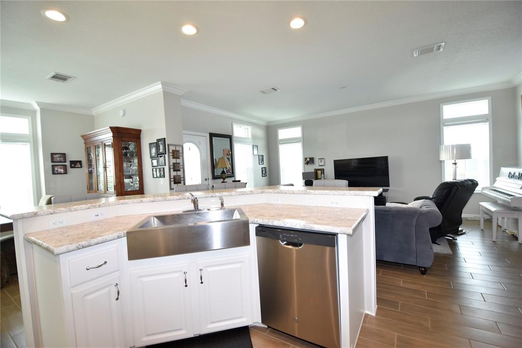 4354 North Manatee Loop, Unit 16A Punta Gorda, FL 33980 - Photo 7 of 33 a living room with stainless steel appliances kitchen island granite countertop a sink and view of living room