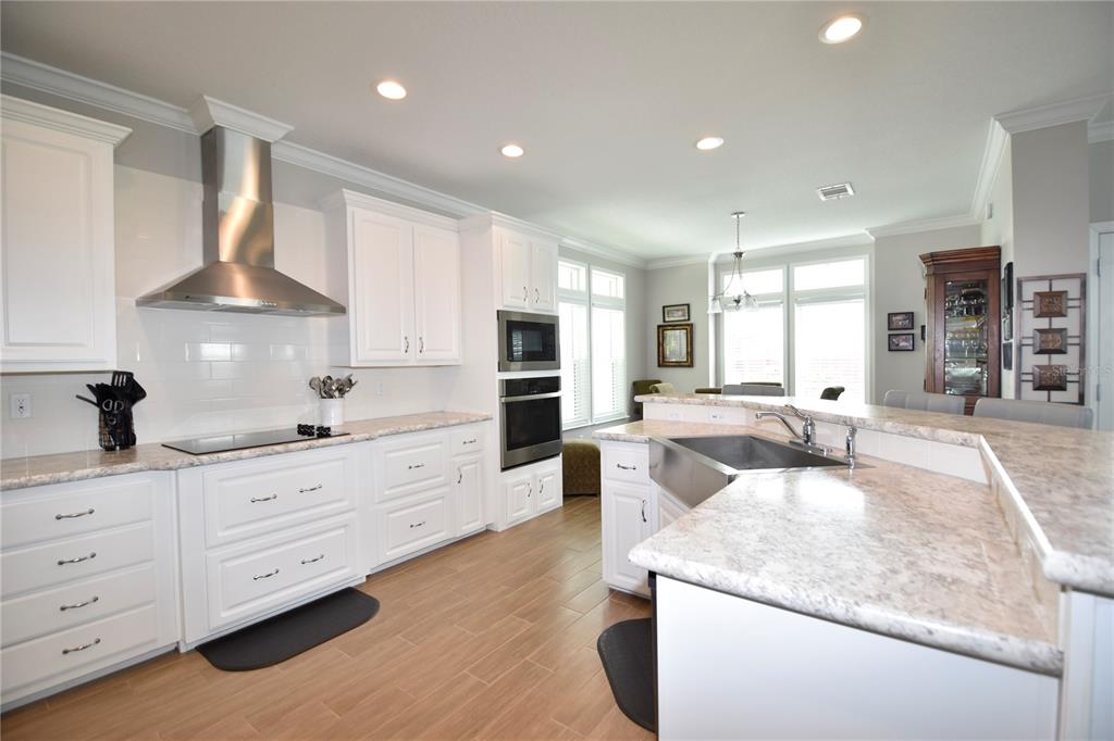 4354 North Manatee Loop, Unit 16A Punta Gorda, FL 33980 - Photo 8 of 33 a large kitchen with stainless steel appliances kitchen island granite countertop a lot of counter space and a sink