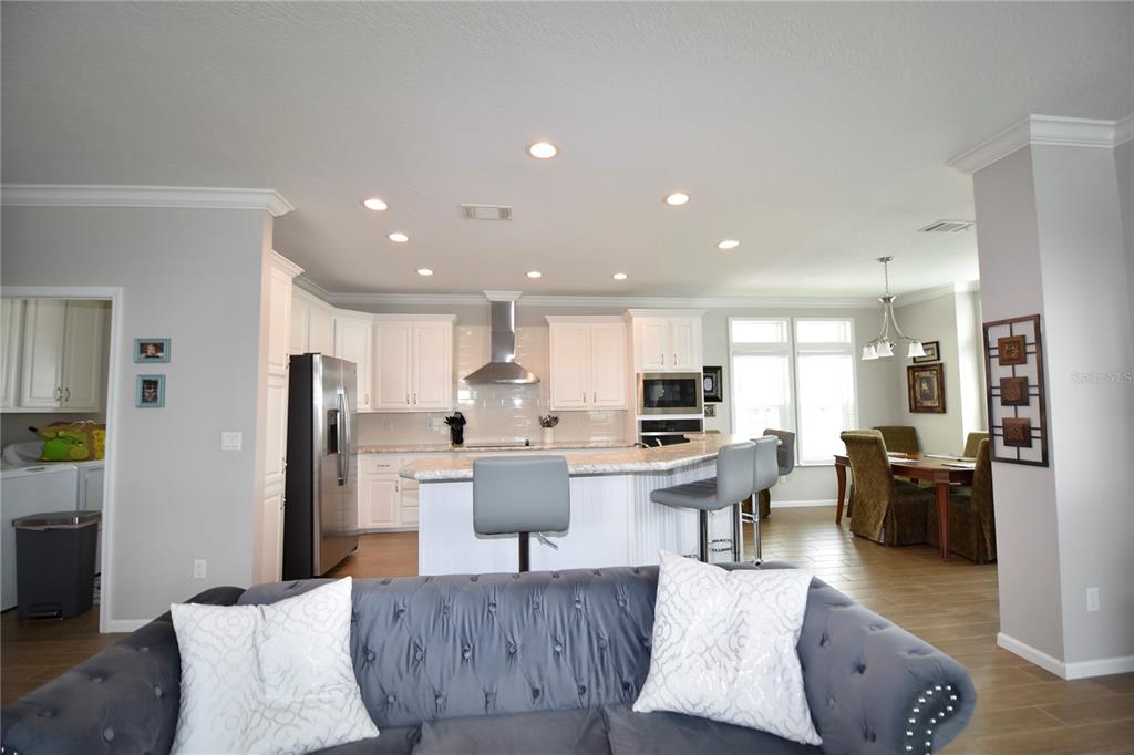 4354 North Manatee Loop, Unit 16A Punta Gorda, FL 33980 - Photo 9 of 33 a living room with stainless steel appliances kitchen island granite countertop furniture a refrigerator a kitchen island a stove and a sink