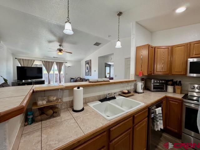 544 20th Street Delta, CO 81416 - Photo 12 of 44 a kitchen with a sink a counter and cabinets