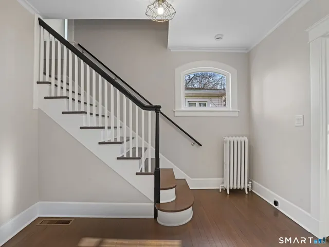 a view of entryway with wooden floor