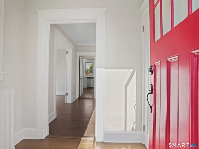 a view of a kitchen with a refrigerator and a window