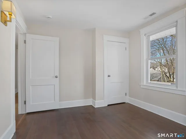 a bathroom with a sink mirror and toilet