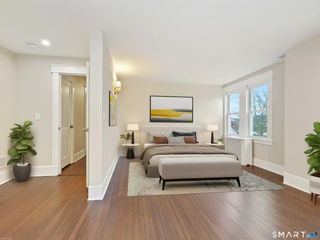a spacious bedroom with a bed and a chandelier