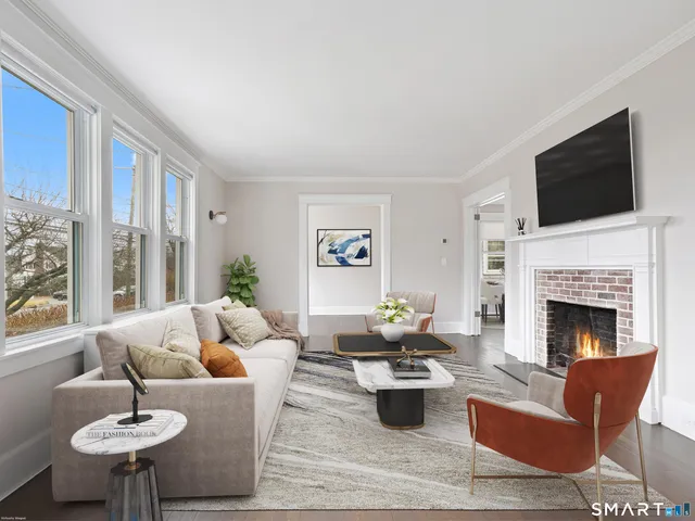 a living room with furniture fireplace and a flat screen tv