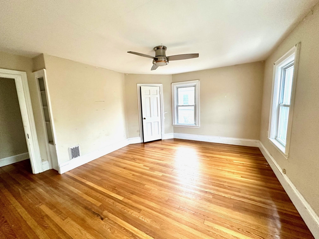 6 Grant Street, Unit 2 Natick, MA 01760 - Photo 11 of 15 wooden floor in an empty room with a window