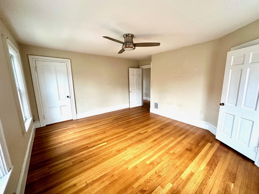 6 Grant Street, Unit 2 Natick, MA 01760 - Photo 12 of 15 a view of empty room with wooden floor
