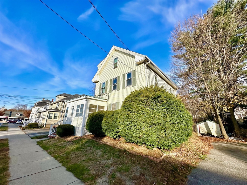 6 Grant Street, Unit 2 Natick, MA 01760 - Photo 4 of 15 a view of multiple houses with a yard