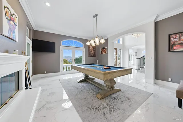 a view of a dining room and a kitchen with a table and chairs