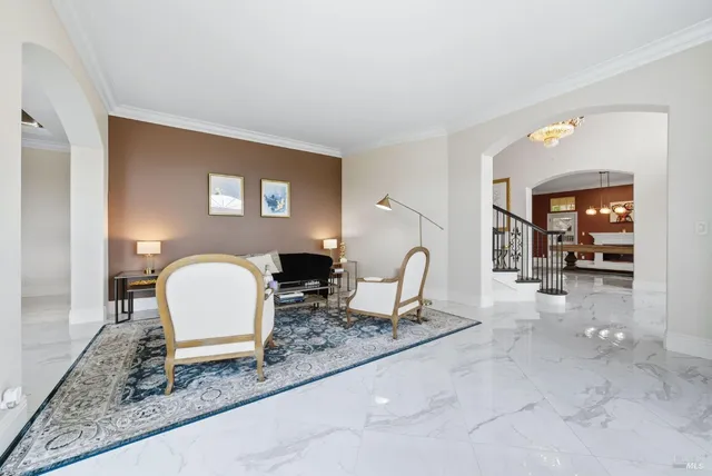 a dining room with furniture a chandelier and wooden floor