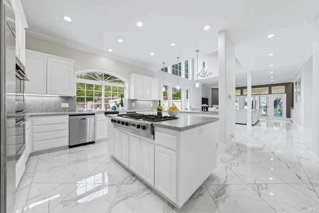a living room with granite countertop furniture and a flat screen tv