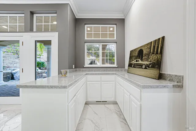 an aerial view of residential houses with outdoor space and trees