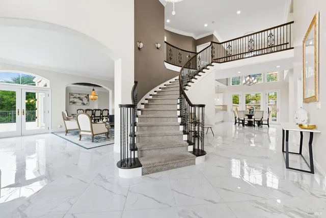 a living room with furniture a rug and white walls