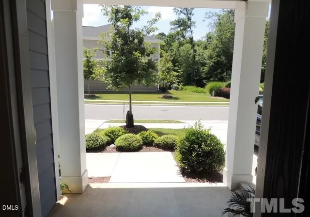 a view of a balcony with yard