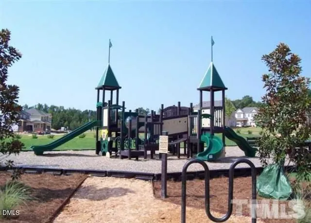 a view of houses with yard and deck